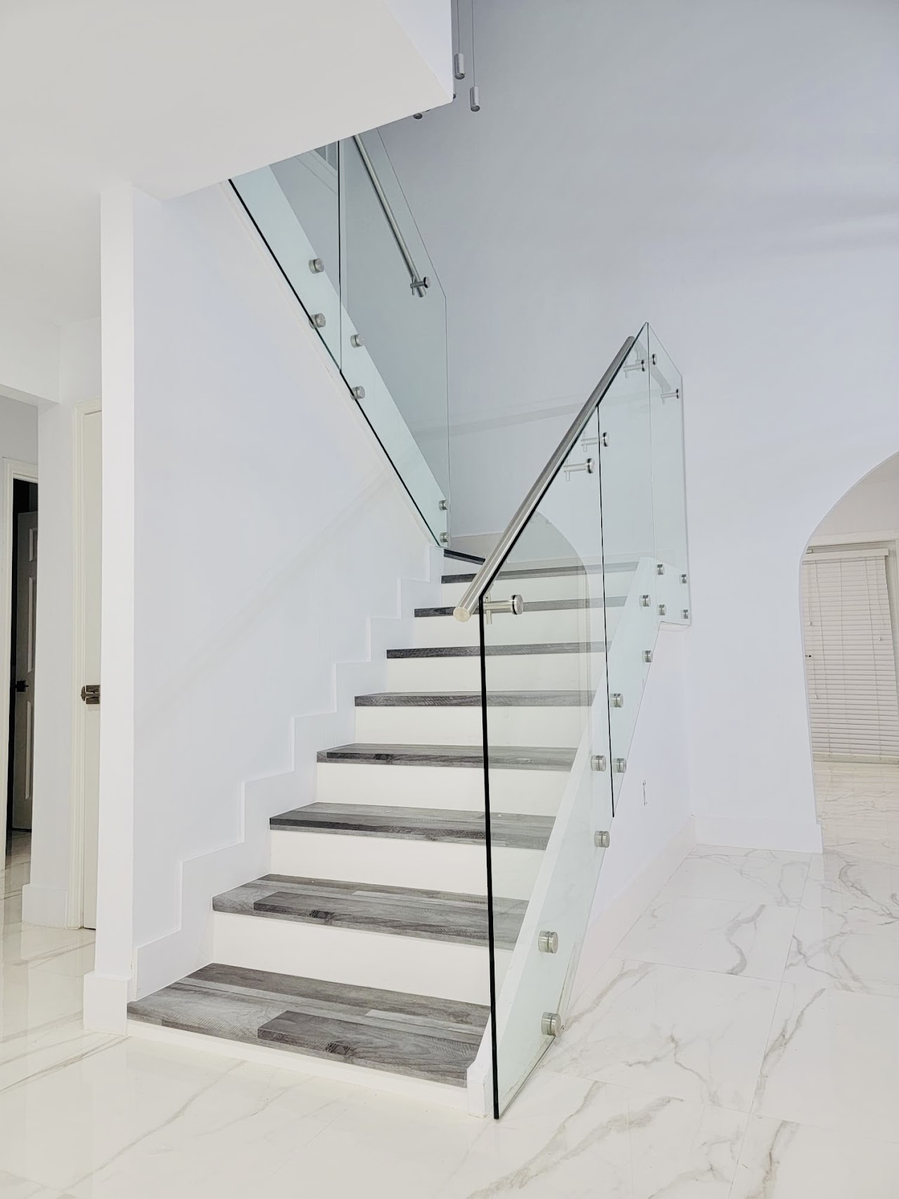 Glass railing along a white staircase
