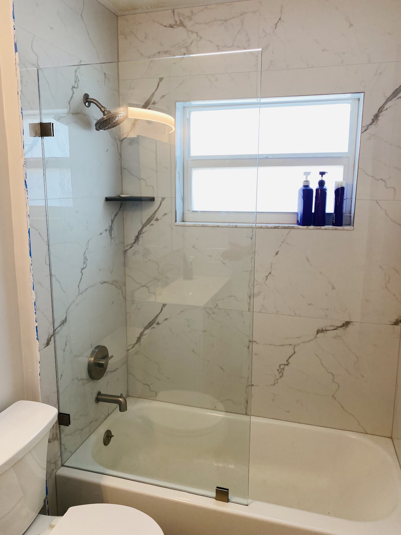 Shower glass beside bathroom window