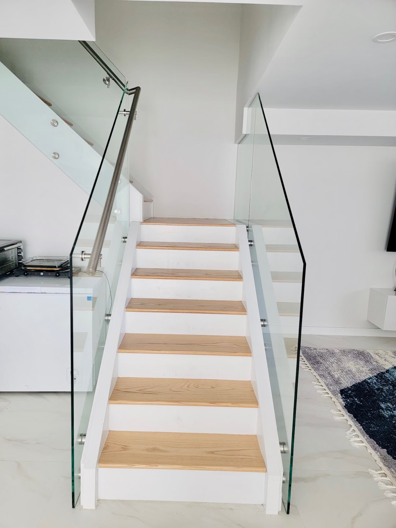 Glass railing along a white staircase