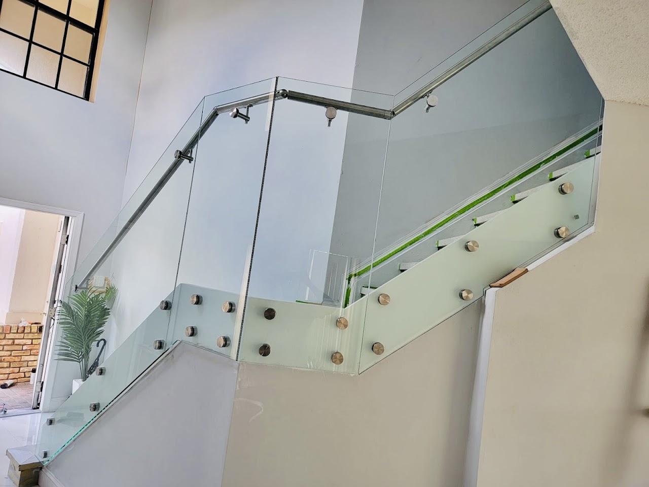 Glass stair railing across landing