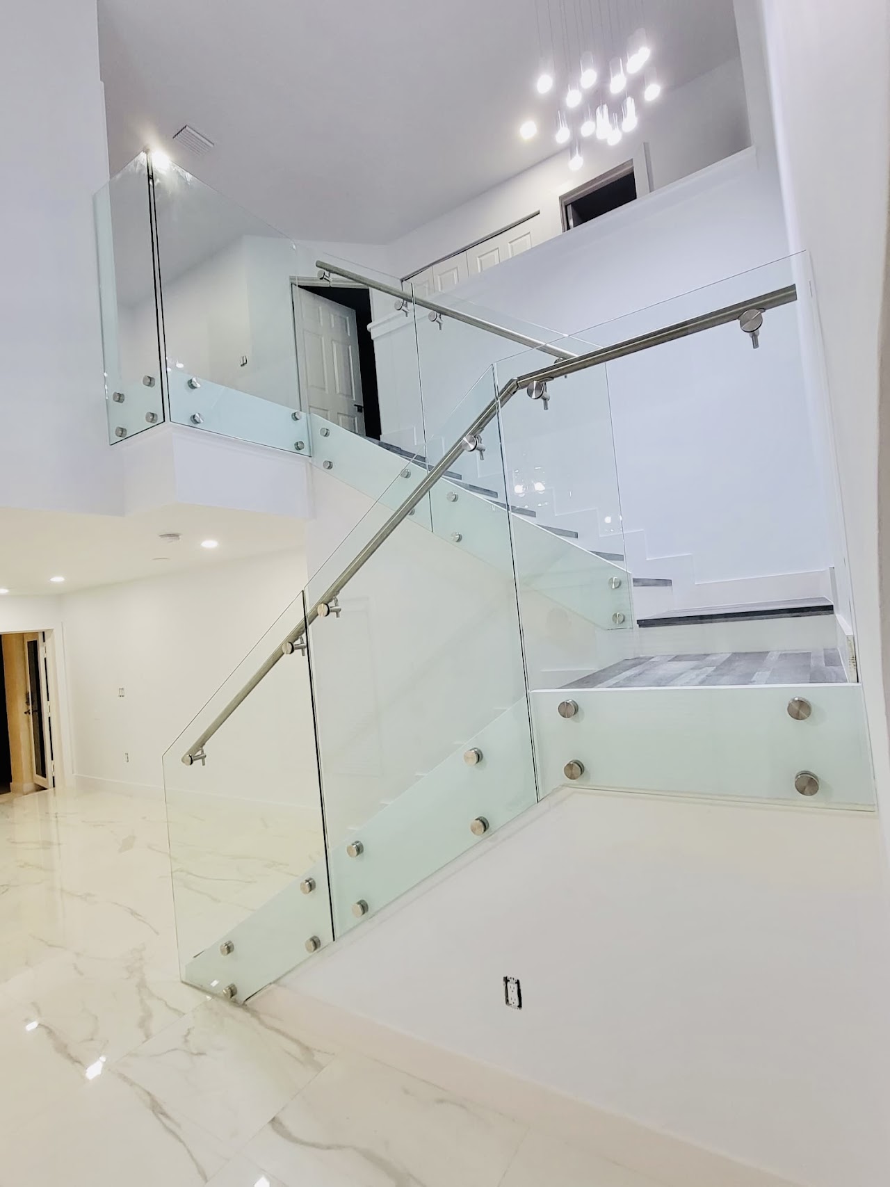 Glass stair railing seen from upper landing